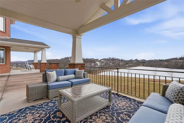 a roof deck with couches and city view