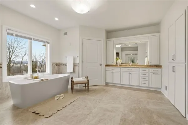 a bathroom with a granite countertop sink a mirror and a shower