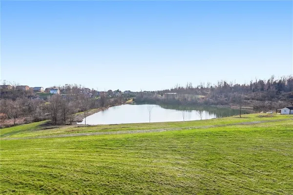 a view of a lake with houses in the back