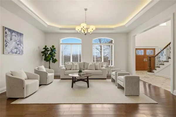 a living room with furniture and a chandelier