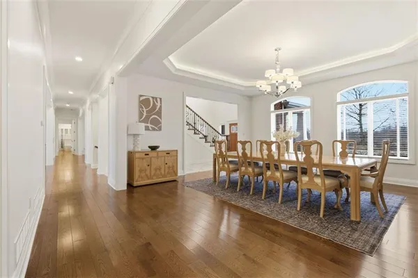 a view of a dining room with furniture and chandelier