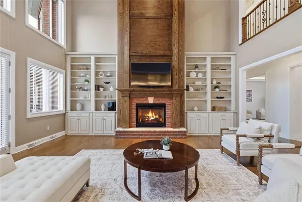 a living room with fireplace furniture and a flat screen tv