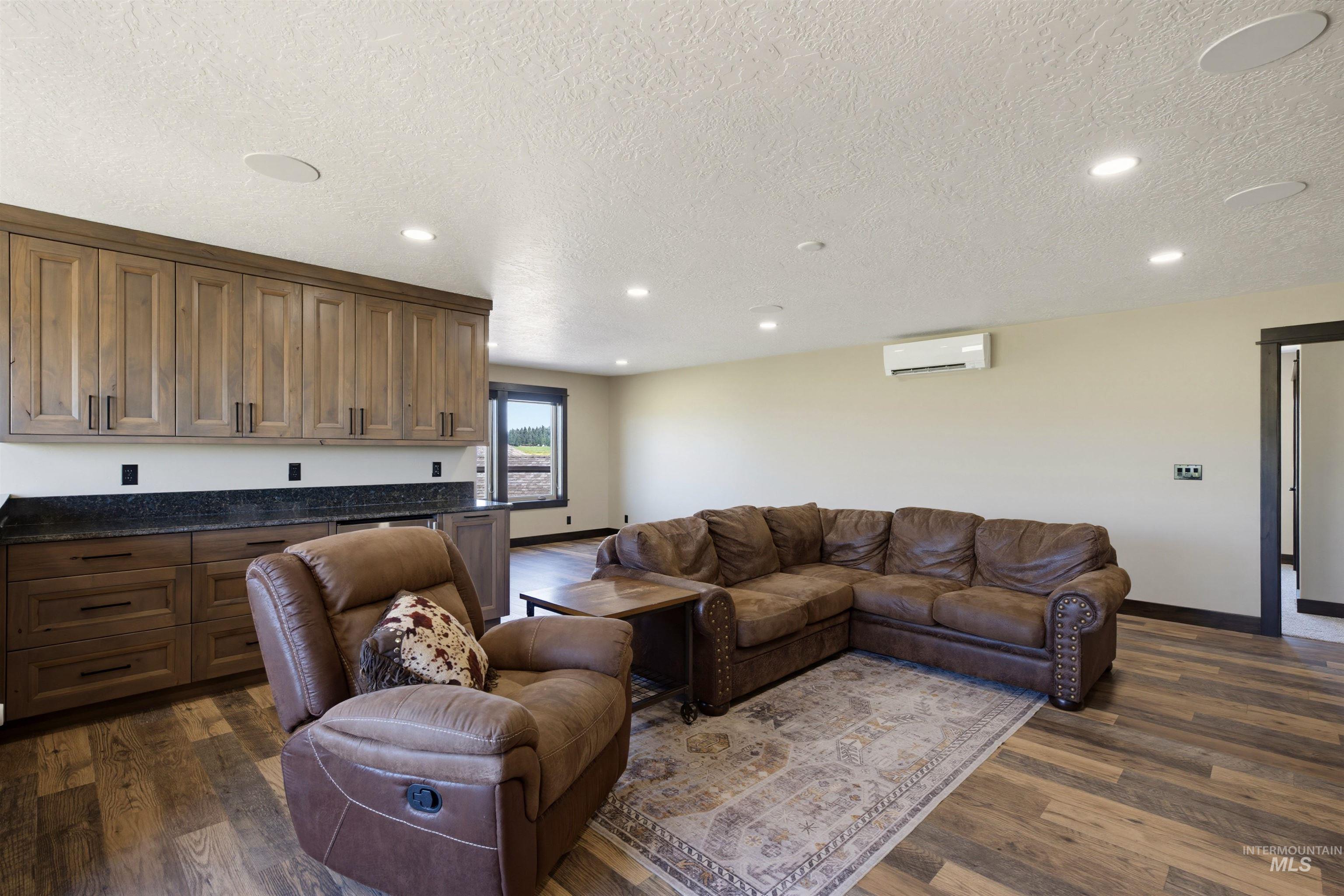 13945 Galloping Road McCall, ID 83638 - Photo 32 of 50 Spacious multi-purpose room featuring wood-finish flooring, recessed lighting, and an extensive built-in cabinetry system with dark countertops
