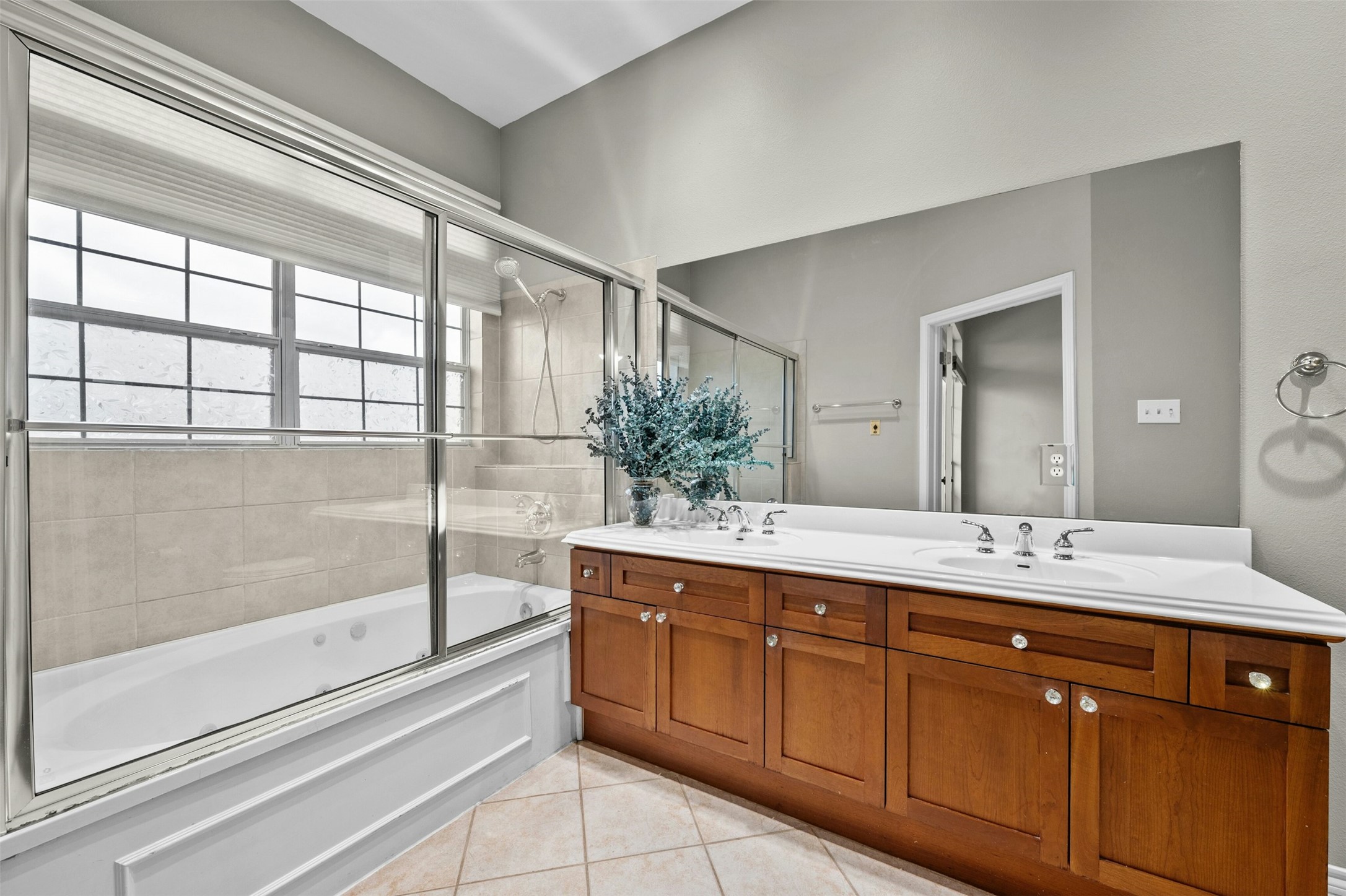 2918 Ranch To Market Road 620, Unit W219 Austin, TX 78734 - Photo 22 of 35 Featuring a large mirror, double sinks, and a jetted soaking tub with shower comb - your own spa escape.