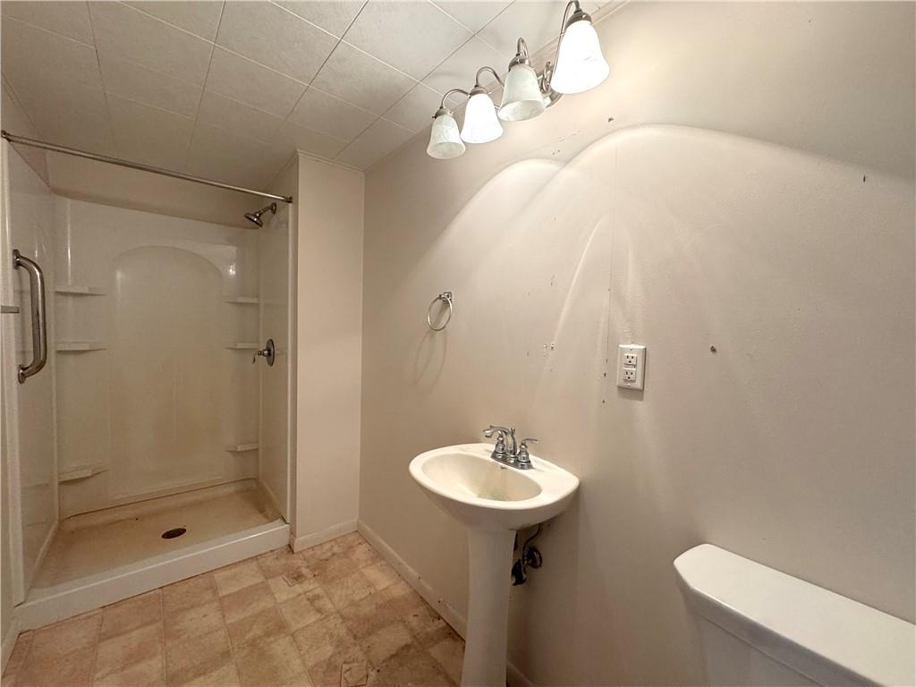 671 Solomon Temple Road Latrobe, PA 15650 - Photo 22 of 32 a bathroom with a sink a toilet and shower