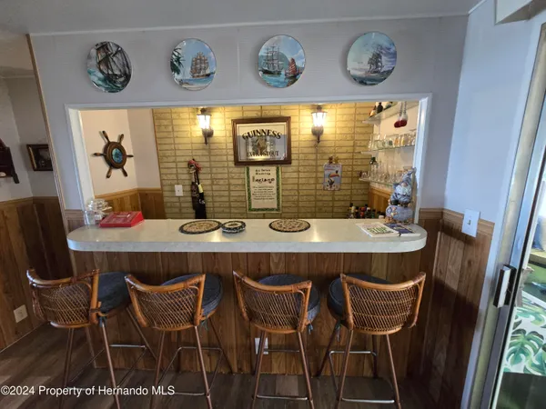 a living room with furniture a rug and a lamp