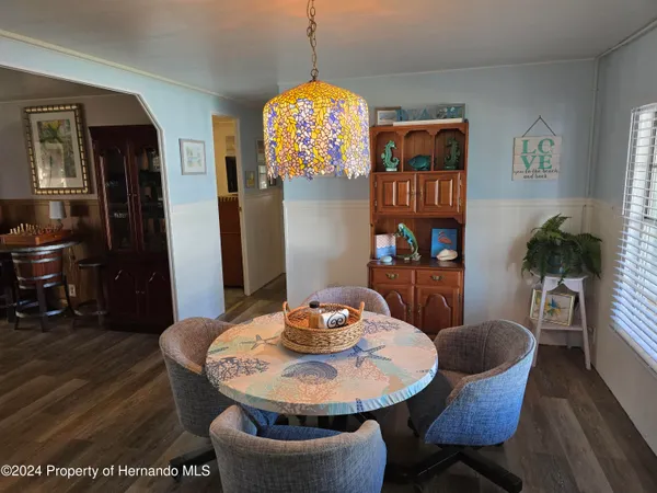 a dining room with furniture and wooden floor