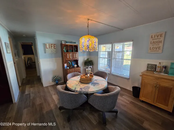 a view of a dining room with furniture and wooden floor