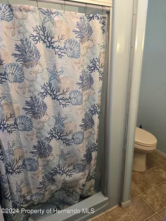 a bedroom with a bed a lamp and a window