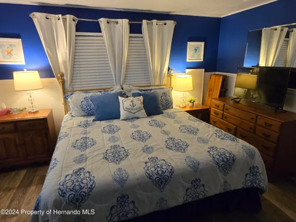 a bedroom with a bed and a mirror