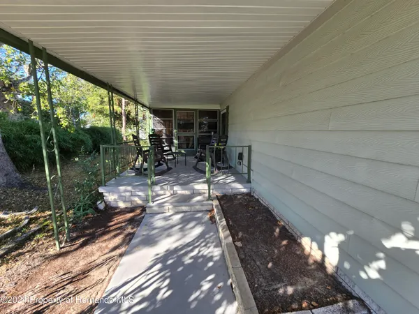 a view of a chairs and table in the balcony