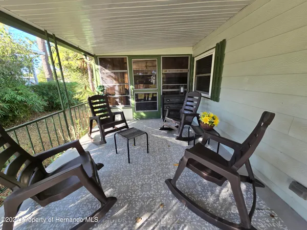 a view of a livingroom with furniture and a potted plant