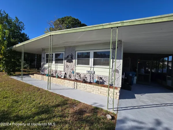 a view of a patio with table and chairs