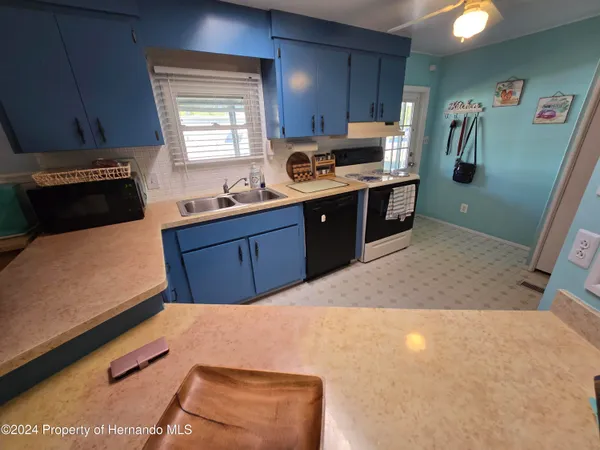 a kitchen with stainless steel appliances a stove a refrigerator and a sink