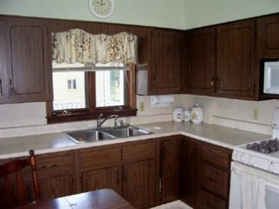 8745 Kleinman Road Highland, IN 46322 - Photo 5 of 8 a kitchen with a sink cabinets and window