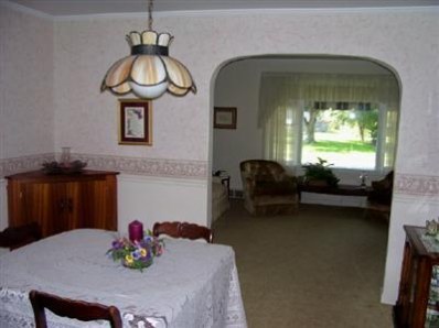 8745 Kleinman Road Highland, IN 46322 - Photo 6 of 8 a view of a dining room with furniture a chandelier and wooden floor