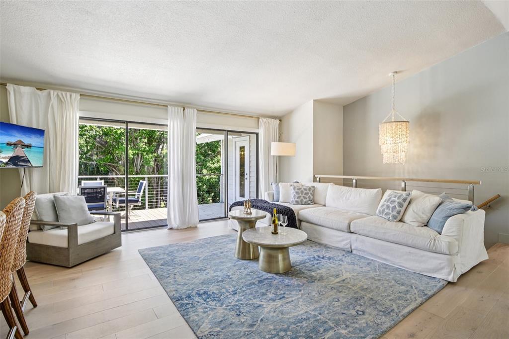 3390 Bayou Sound Longboat Key, FL 34228 - Photo 2 of 59 a living room with furniture and a large window