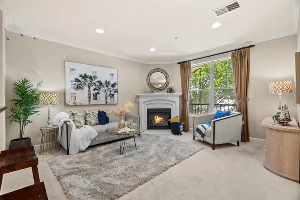 a living room with furniture and a fireplace