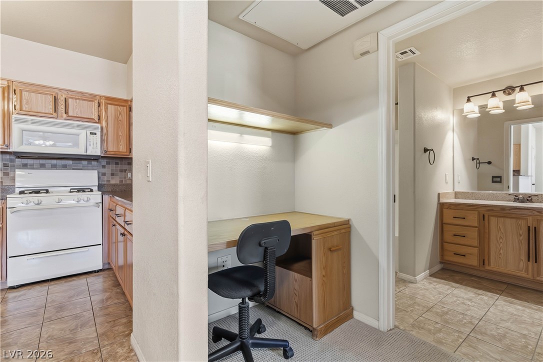 10550 West Alexander Road, Unit 2060 Las Vegas, NV 89129 - Photo 24 of 45 A clever office nook perfectly complements the adjacent well-appointed kitchen and convenient bathroom.