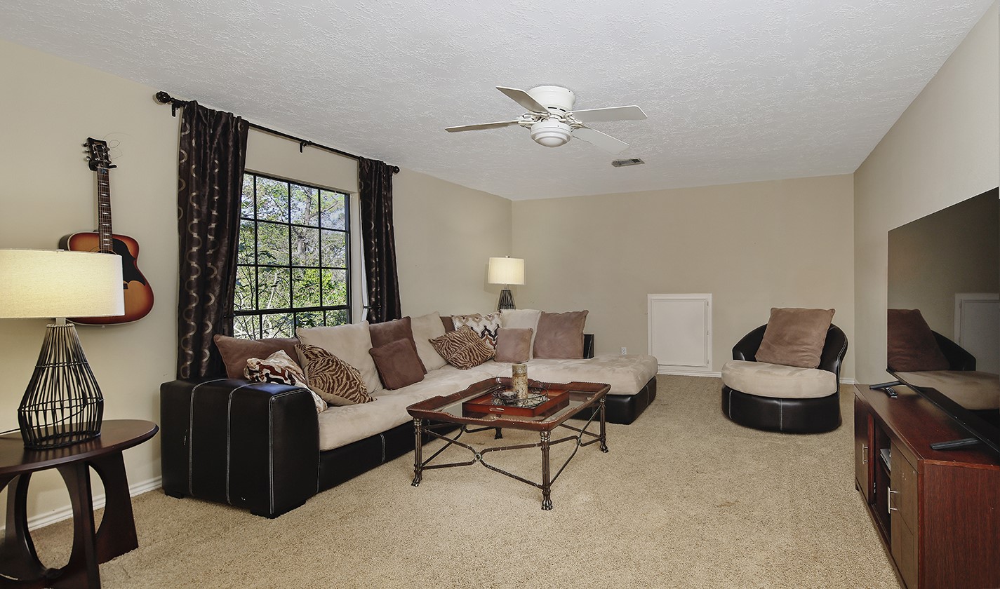 24635 West Kingscrest Circle Spring, TX 77389 - Photo 25 of 38 a living room with furniture ceiling fan and a window