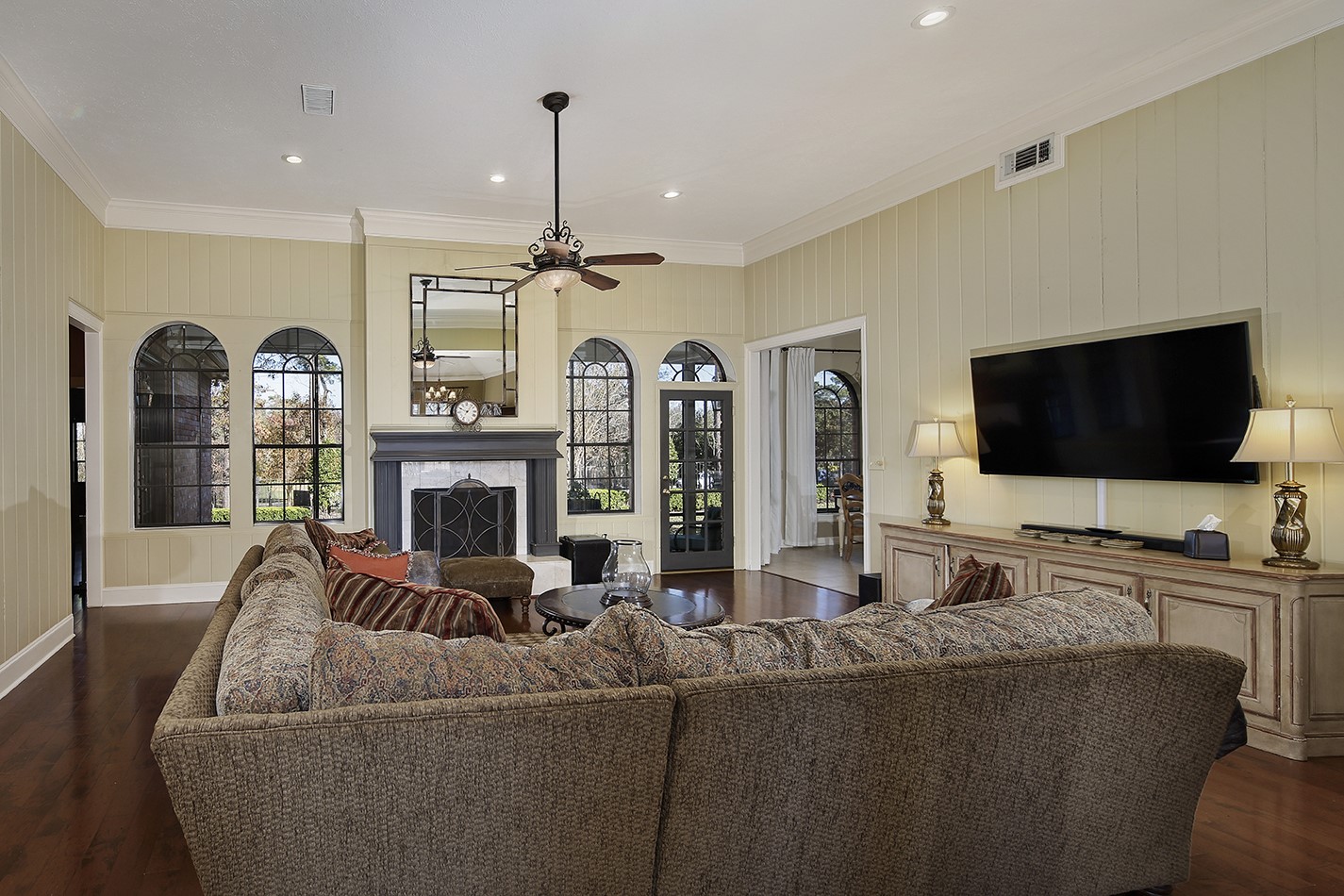 24635 West Kingscrest Circle Spring, TX 77389 - Photo 10 of 38 a living room with furniture a flat screen tv and a chandelier
