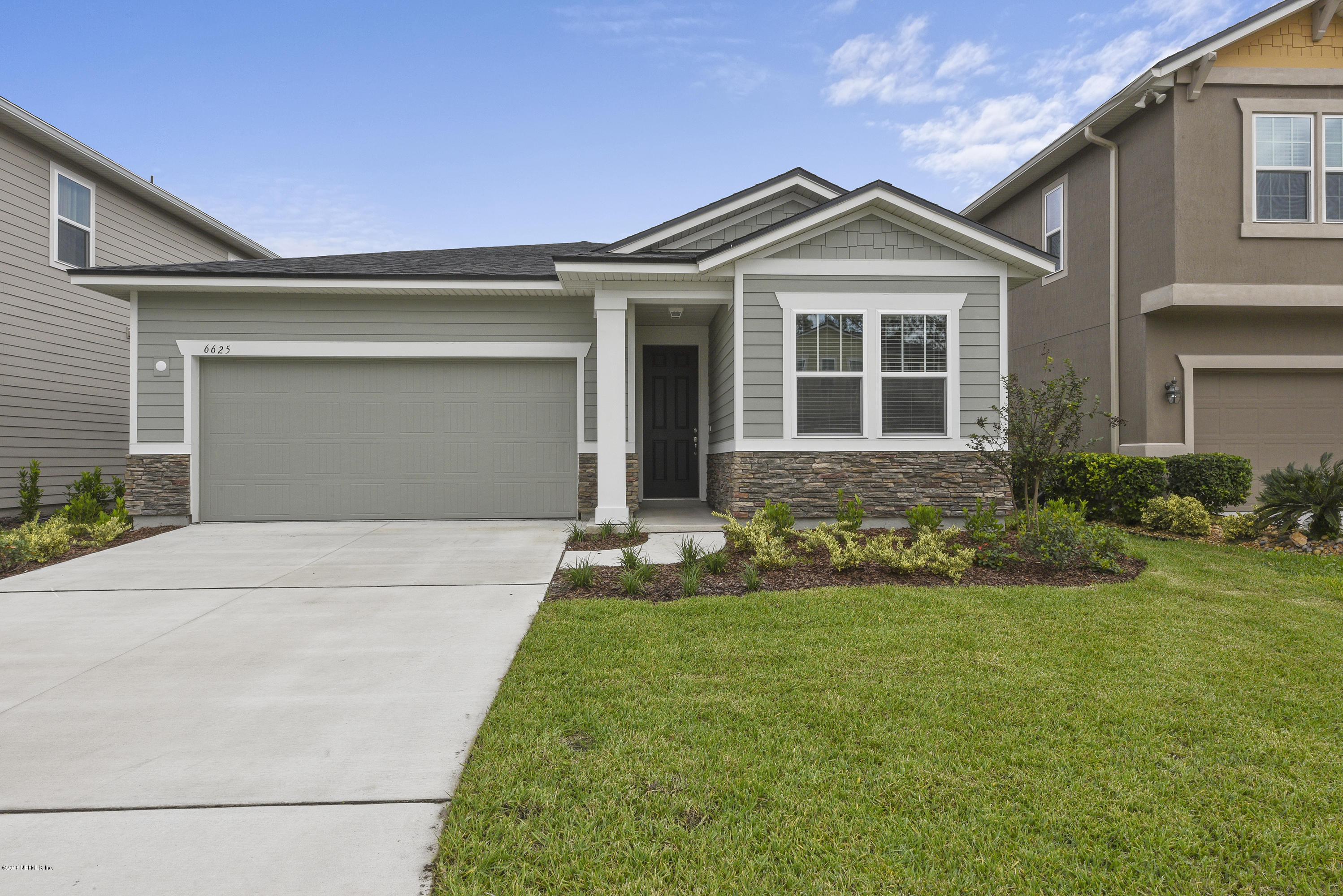 6625 Azalea Park Road Jacksonville, FL 32259 - Photo 1 of 26 a front view of a house with a yard and garage