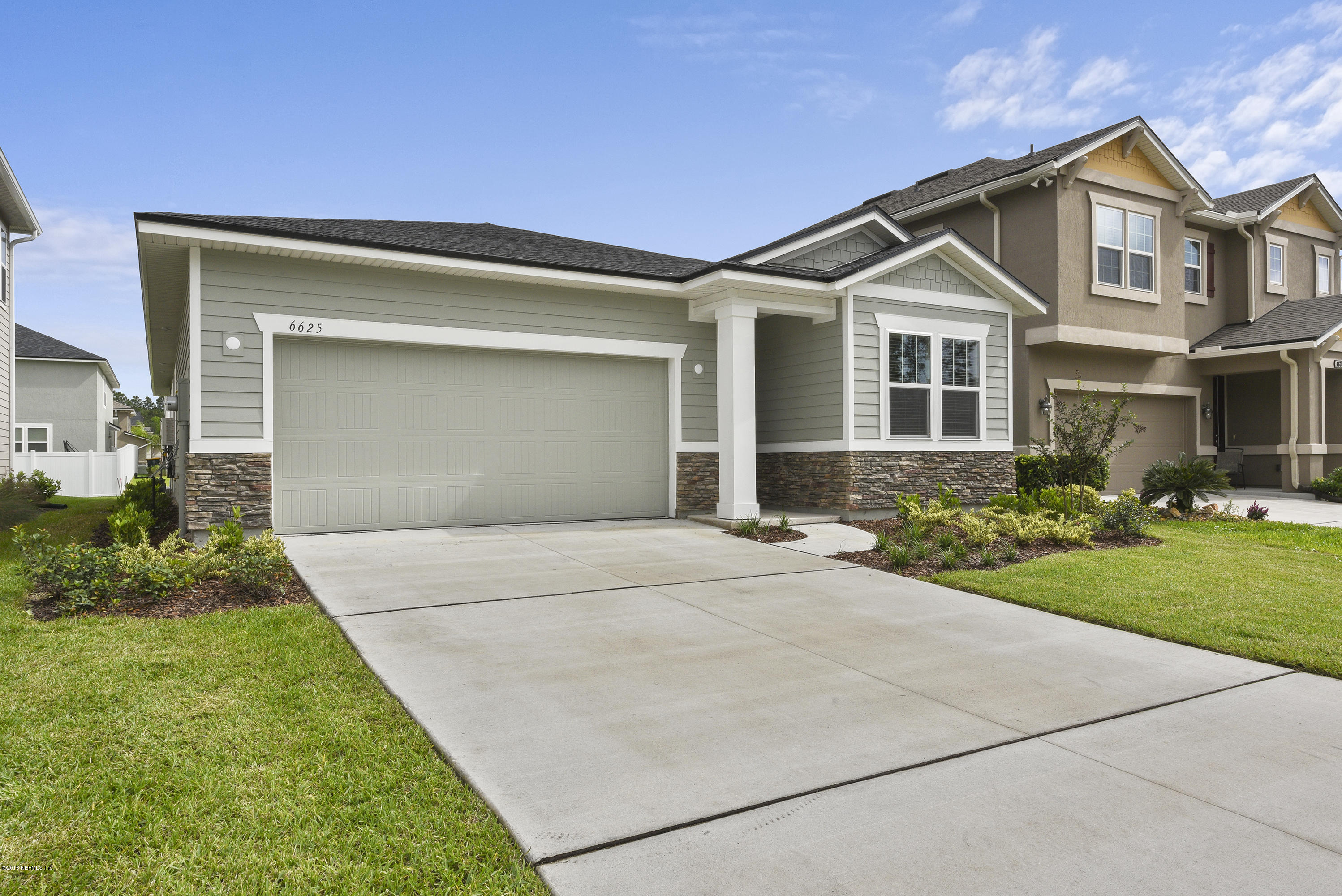 6625 Azalea Park Road Jacksonville, FL 32259 - Photo 2 of 26 a front view of a house with a yard and garage