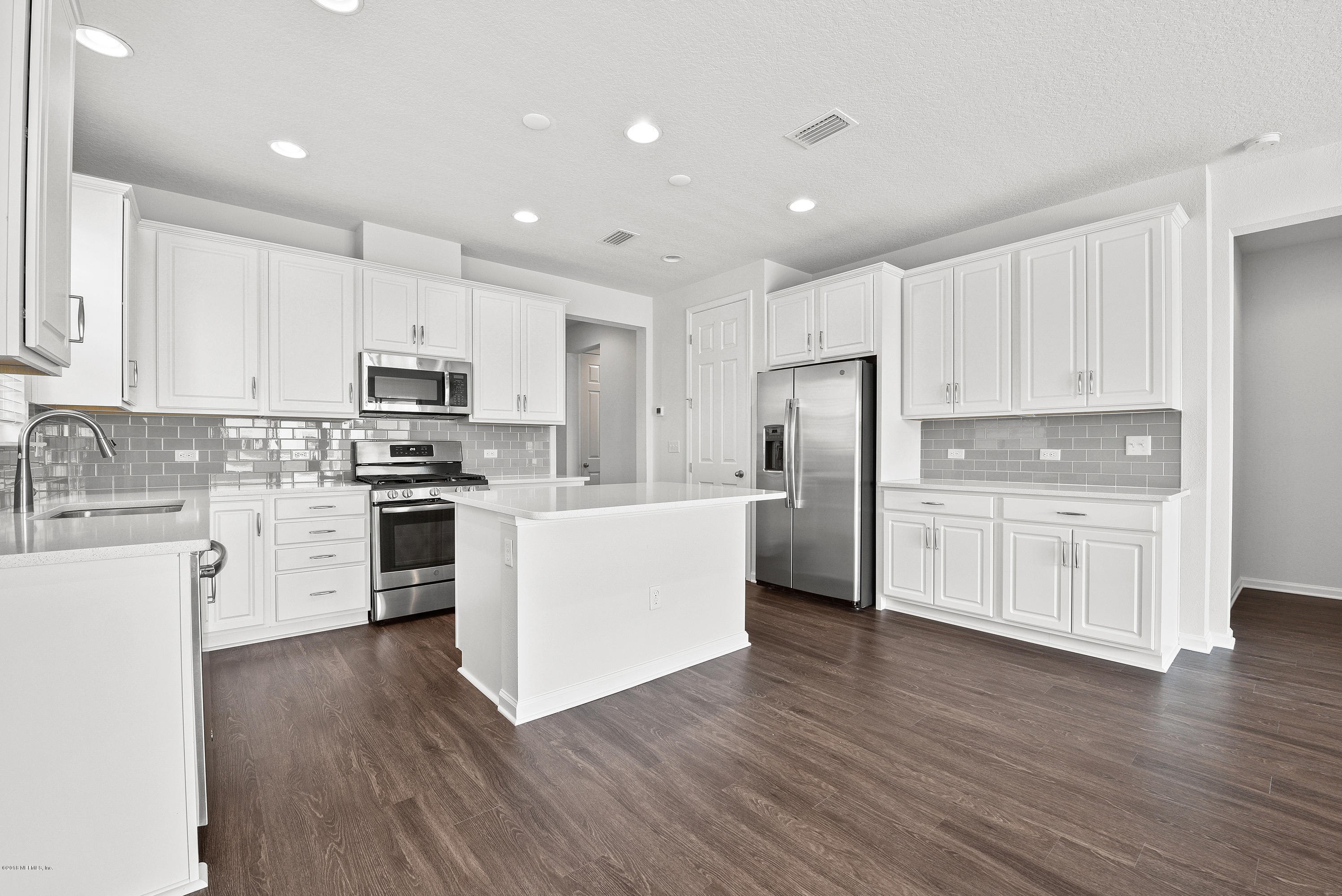 6625 Azalea Park Road Jacksonville, FL 32259 - Photo 6 of 26 a kitchen with white cabinets stainless steel appliances and sink