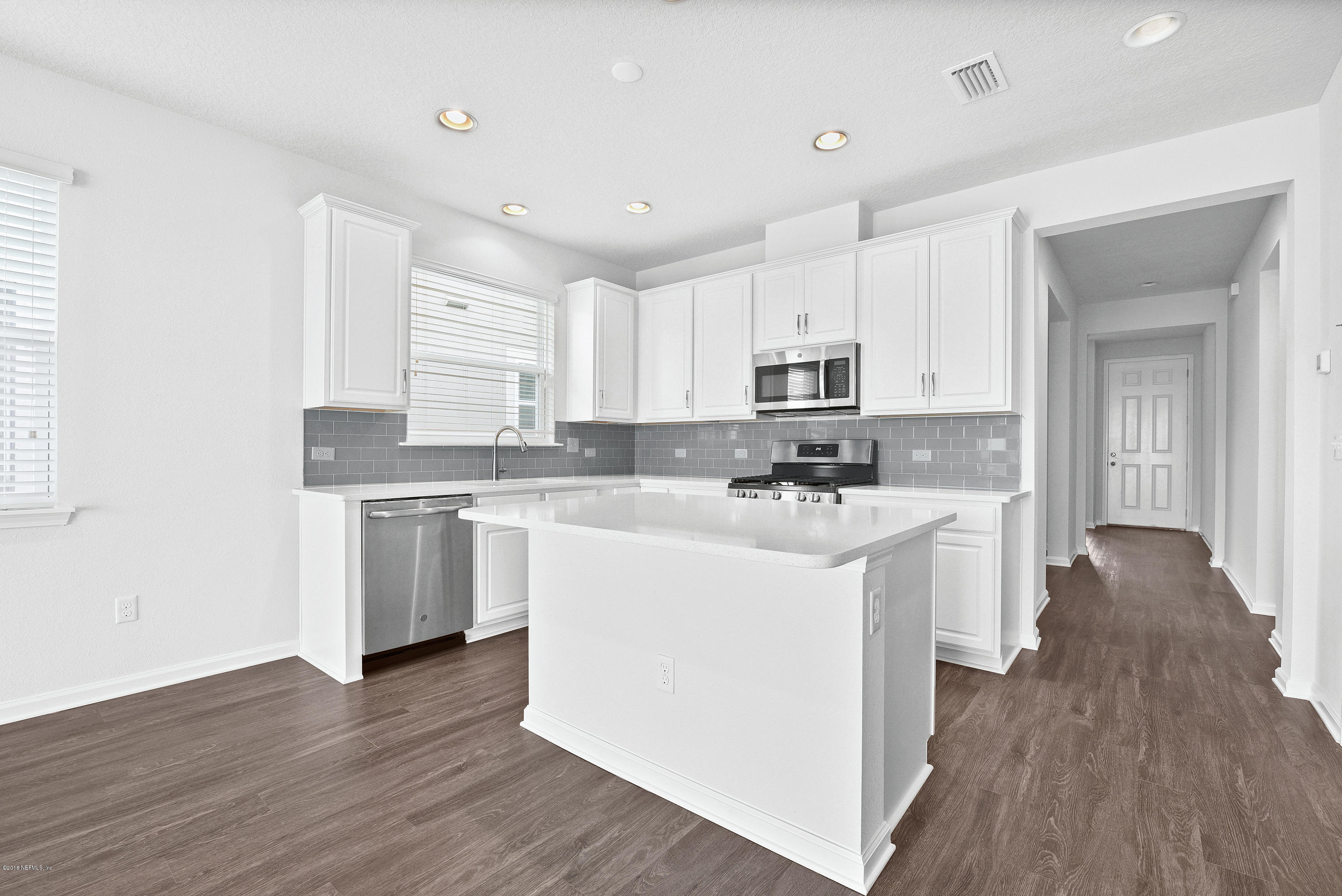 6625 Azalea Park Road Jacksonville, FL 32259 - Photo 7 of 26 a kitchen with stainless steel appliances white cabinets a sink a stove a refrigerator and a microwave