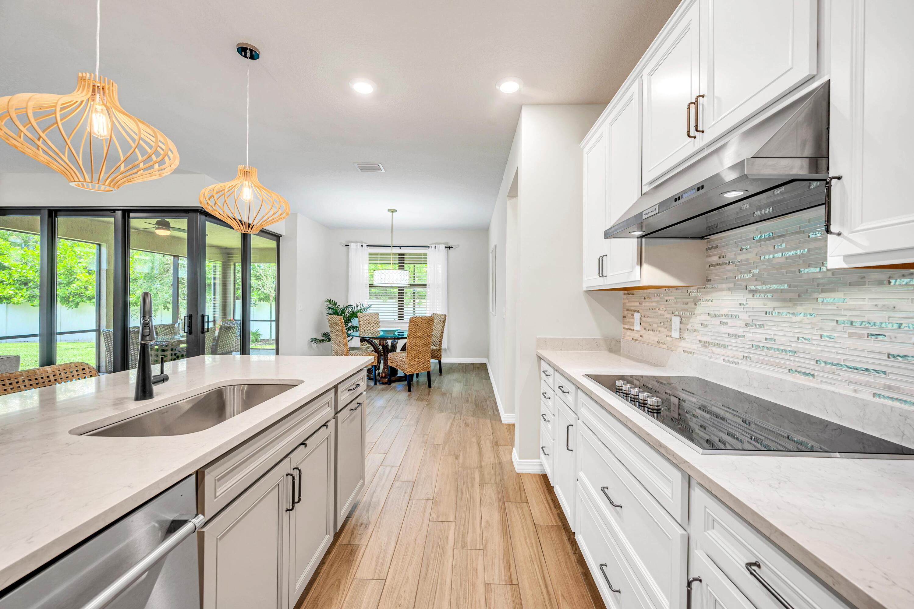 8028 Northwest 78th Street Tamarac, FL 33321 - Photo 6 of 38 a kitchen with sink stove and cabinets