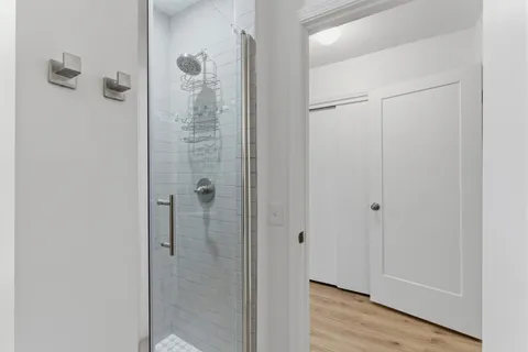 a bathroom with a glass shower door