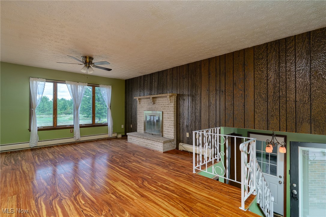 6747 Giddings Road Rootstown, OH 44272 - Photo 5 of 39 Living room with wood burning fireplace and picture window with outside views