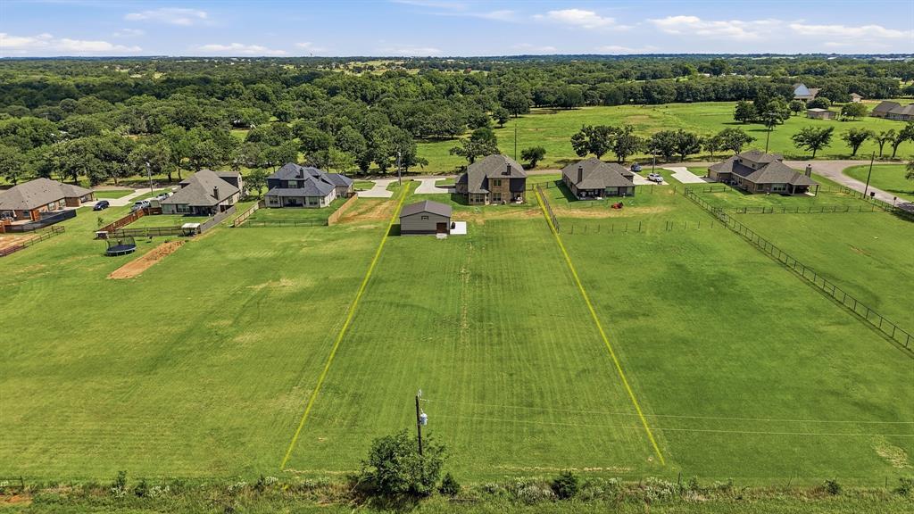 864 Shadow Valley Road Whitesboro, TX 76273 - Photo 6 of 40 Expansive green lot featuring clearly marked property boundaries and a distant tree line
