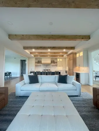 a living room with furniture and view of kitchen