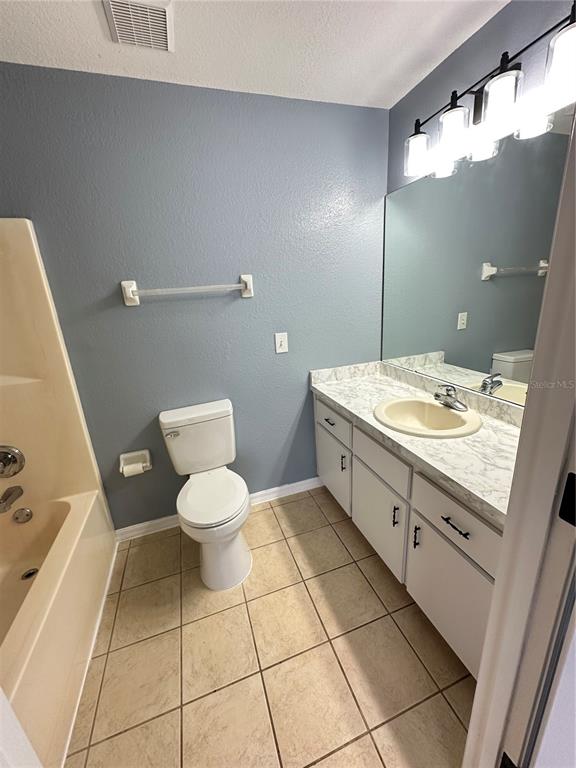 5140 Southwest 159th Street Ocala, FL 34473 - Photo 12 of 13 a bathroom with a toilet a sink and mirror