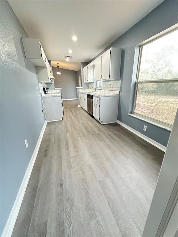5140 Southwest 159th Street Ocala, FL 34473 - Photo 3 of 13 a view of a kitchen with wooden floor and electronic appliances