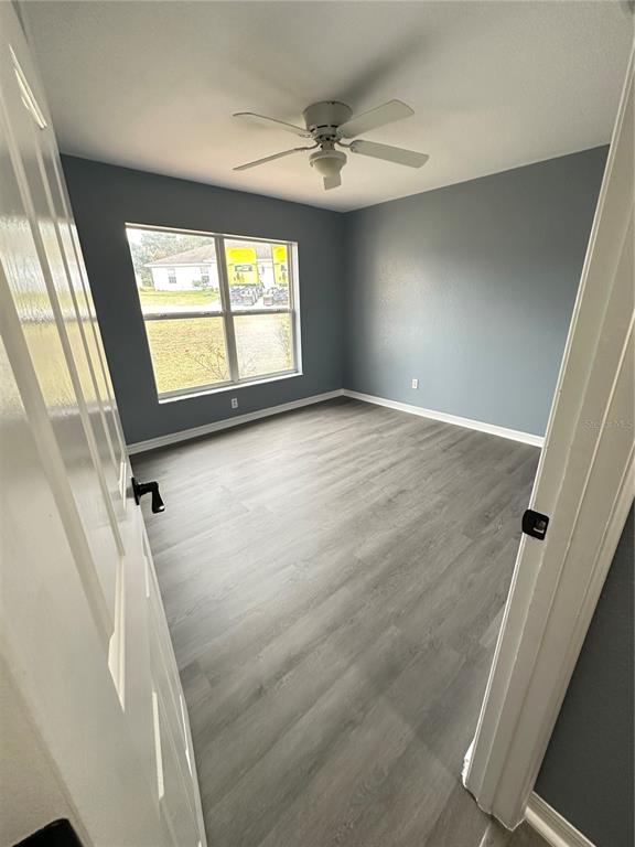 5140 Southwest 159th Street Ocala, FL 34473 - Photo 5 of 13 wooden floor in an empty room with a window