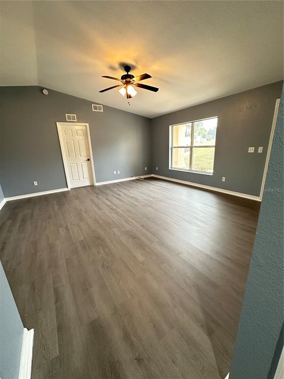 5140 Southwest 159th Street Ocala, FL 34473 - Photo 6 of 13 an empty room with windows and ceiling fan