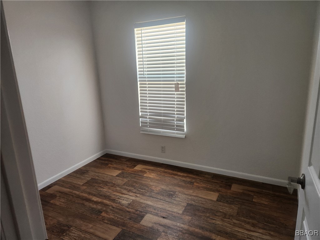60784 Stagemans Road Landers, CA 92285 - Photo 4 of 9 a view of an empty room with wooden floor and a window