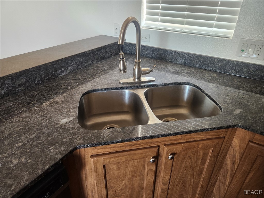 60784 Stagemans Road Landers, CA 92285 - Photo 8 of 9 a kitchen with granite countertop a sink and a wooden floor