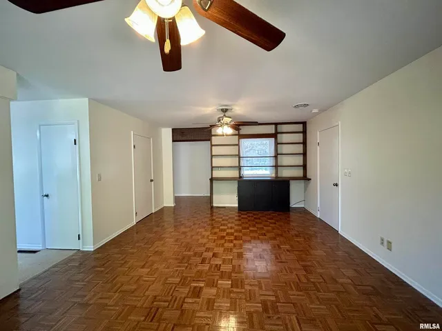 a view of empty room with ceiling fan