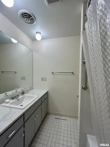 a bathroom with a sink a toilet and a shower