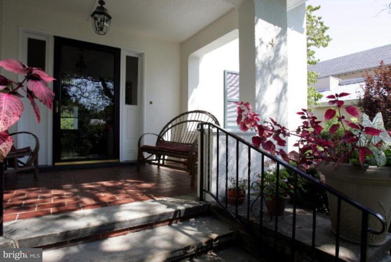 4 Longwood Road Baltimore, MD 21210 - Photo 2 of 23 a view of a porch with a table and chairs and potted plants