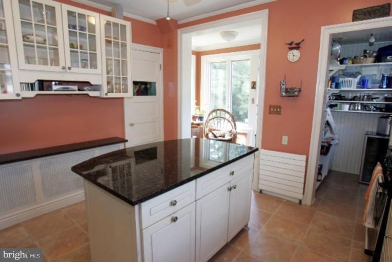 4 Longwood Road Baltimore, MD 21210 - Photo 11 of 23 a kitchen with stainless steel appliances granite countertop a sink and dishwasher with wooden floor