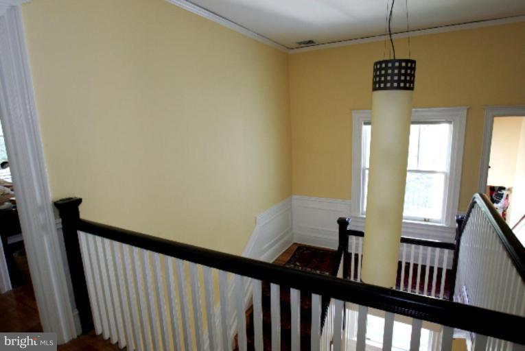 4 Longwood Road Baltimore, MD 21210 - Photo 13 of 23 a view of a hallway view with wooden floor and stairs
