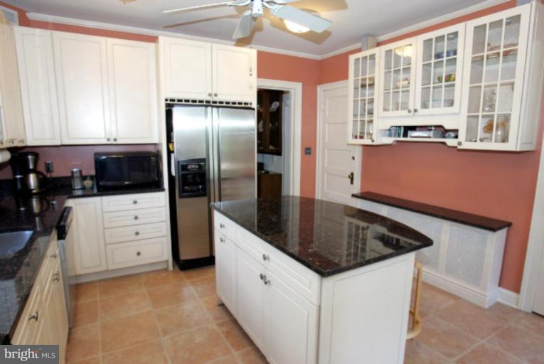 4 Longwood Road Baltimore, MD 21210 - Photo 10 of 23 a kitchen with white cabinets and refrigerator