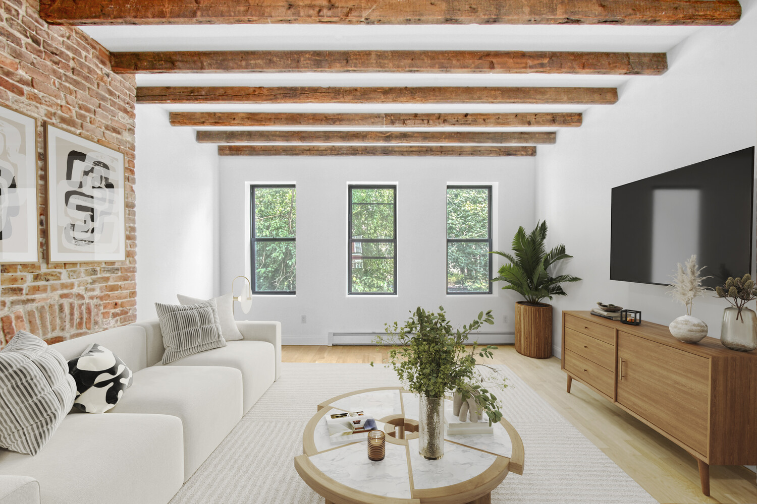 a living room with furniture and a potted plant