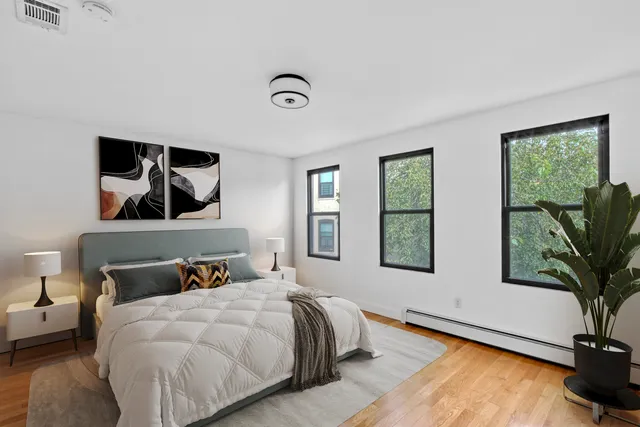 a view of a kitchen with wooden floor and electronic appliances