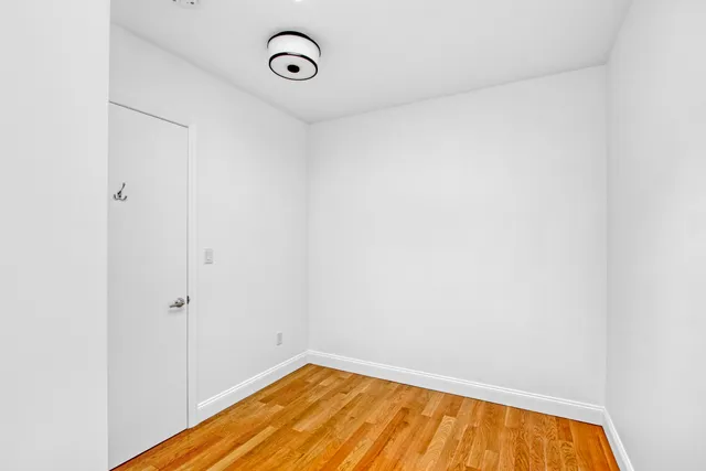 a view of a room with wooden floor