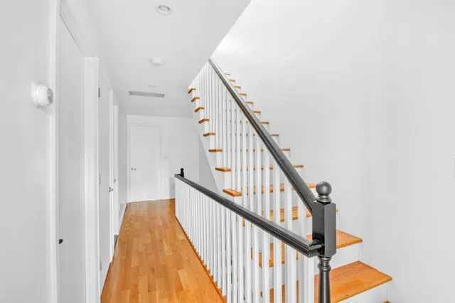 a view of staircase with wooden floor and stairs
